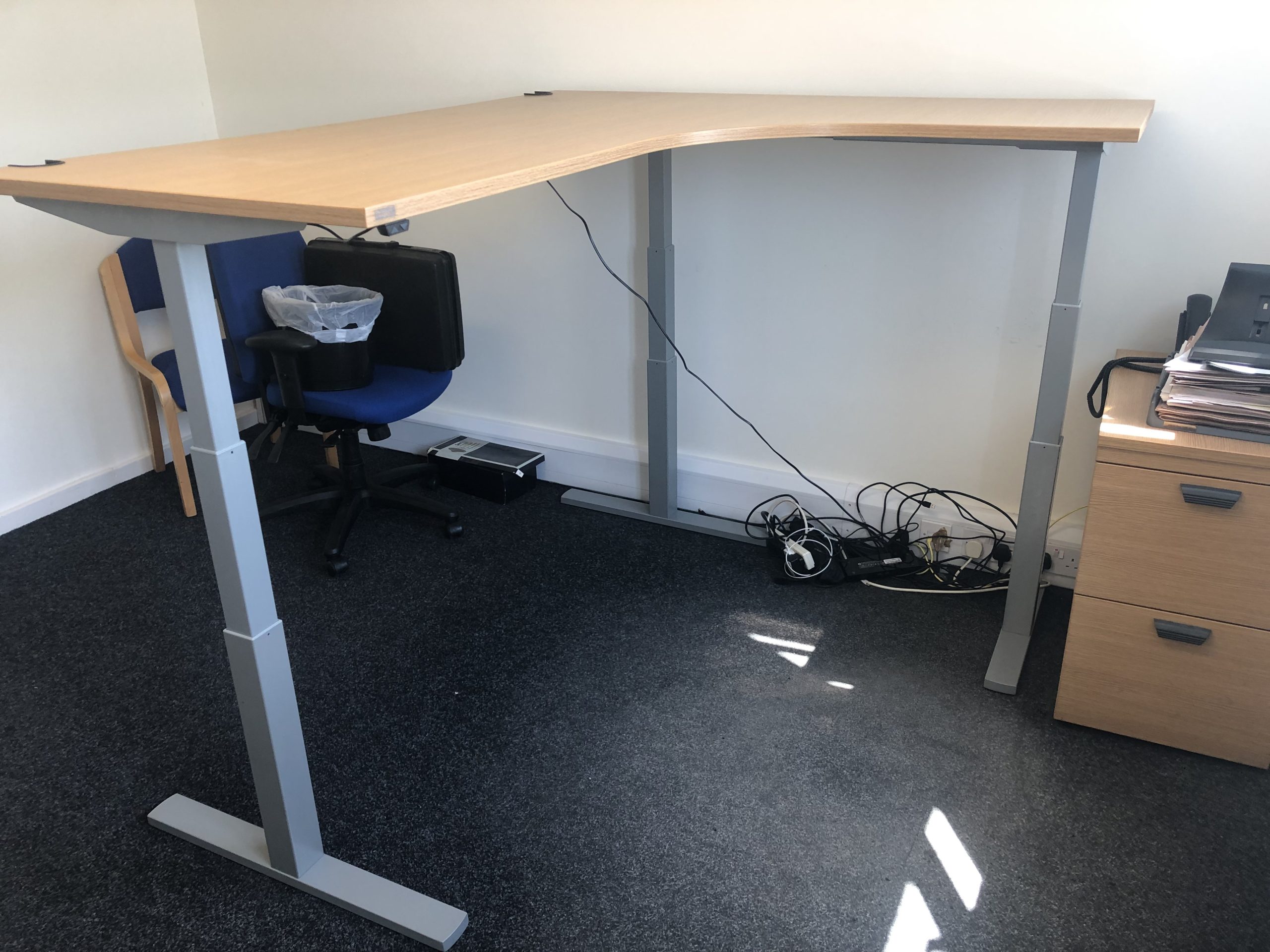 Standard old desk converted to up-down standing electric desk with existing top